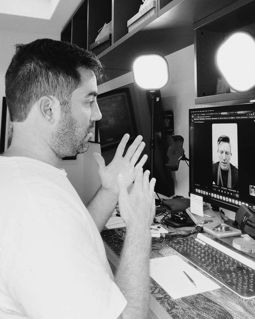 Brian Stewart at his desk on a video call, explaining with both hands